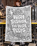 High Fashion colouring blanket held open by an adult model in a zine workroom, showing the uncoloured artwork