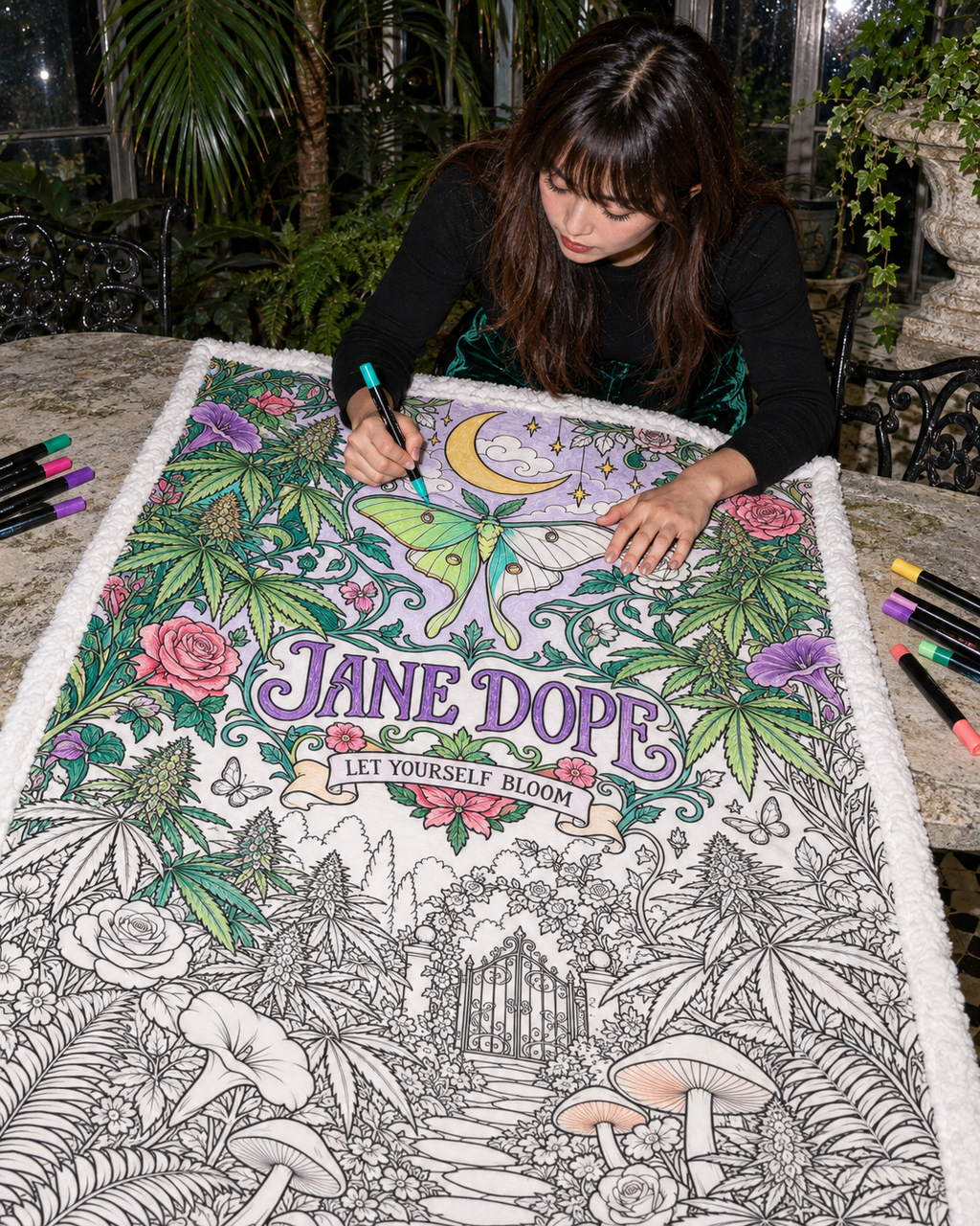 JD Magic colouring inspiration with an adult adding marker colour to the partly coloured luna moth design; supplied uncoloured