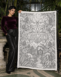 JD Magic uncoloured blanket displayed beside an adult model in a conservatory, showing the luna moth and garden artwork