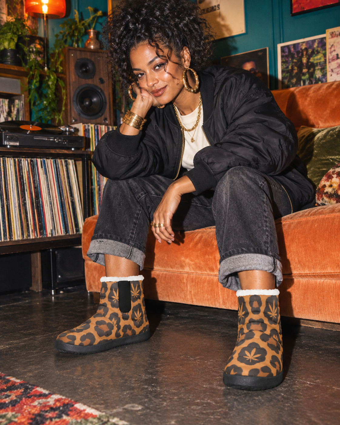 Leopard-and-Herb print booties styled with cuffed denim, a black bomber and gold jewellery in a teal and apricot listening room.
