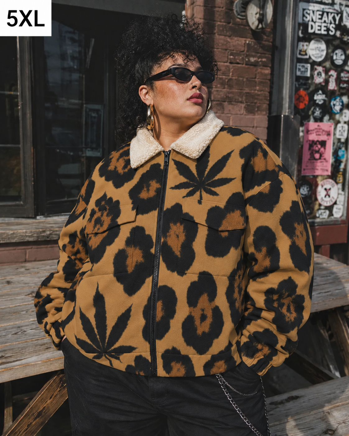 Jane Dope leopard-and-leaf jacket on model in 5XL, standing by a picnic table