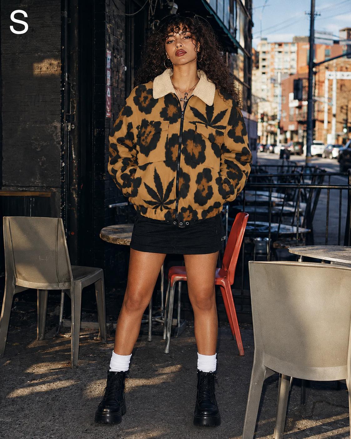 Full-length view of Jane Dope leopard-and-leaf jacket on model in S, standing on a city patio