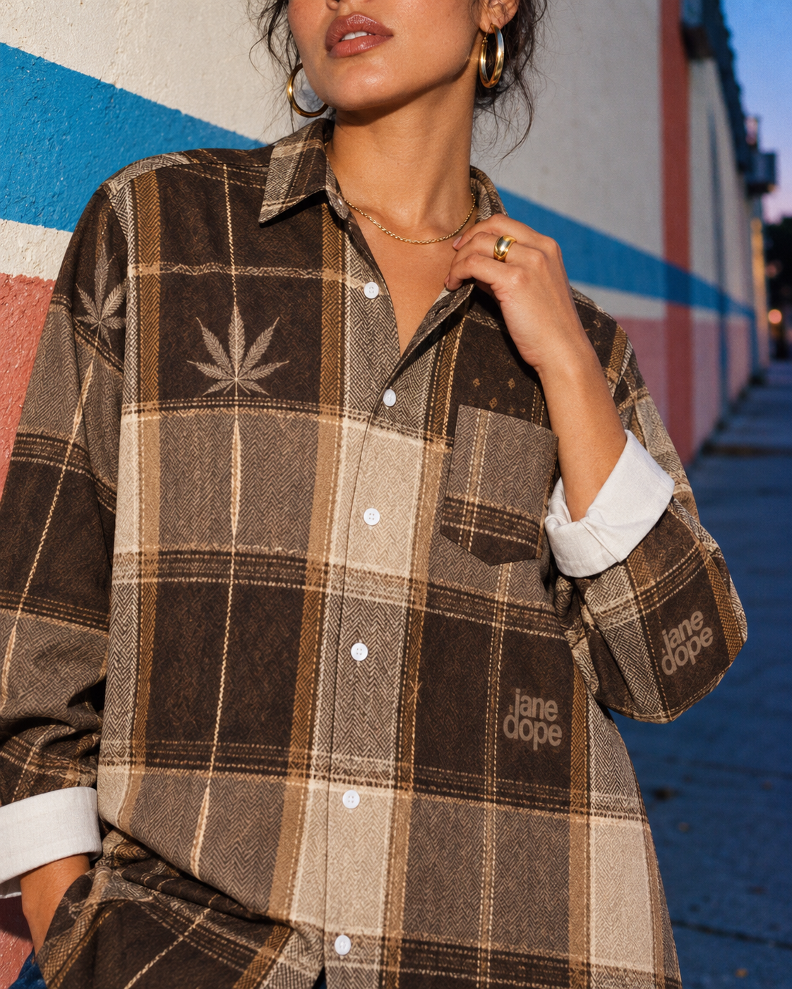 Close-up of the Lumber Jane cotton shirt collar, white buttons, chest pocket and flat brown plaid Herb print.