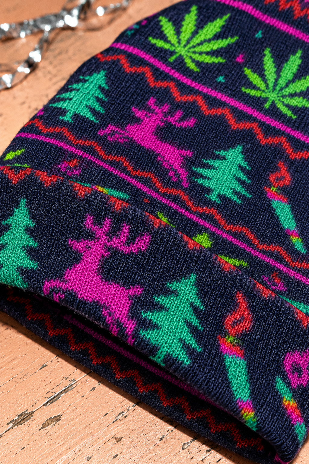 Neon Xmas Beanie fine knit and folded cuff close-up showing pink reindeer and green trees