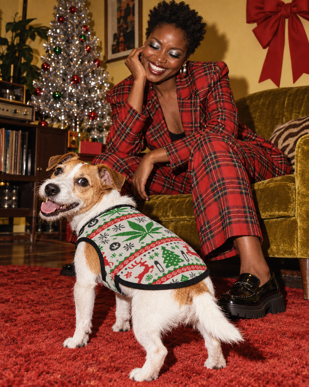 OG Holiday Dog Tank Top on a terrier beside a model in a festive vintage living-room editorial, showing the printed back and black trim.