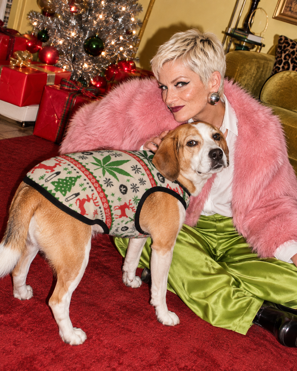 OG Holiday Dog Tank Top on a dog resting beside a model in festive fashion styling, with the full side and back of the tank visible.