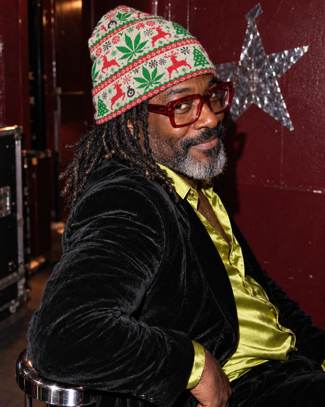 OG Xmas Beanie in an editorial side portrait with a black velvet blazer and festive tinsel backdrop