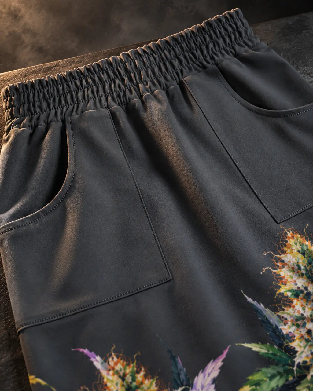 Close-up of the Permanent Marker Pencil Skirt elastic waistband, curved front pocket openings and charcoal fabric.