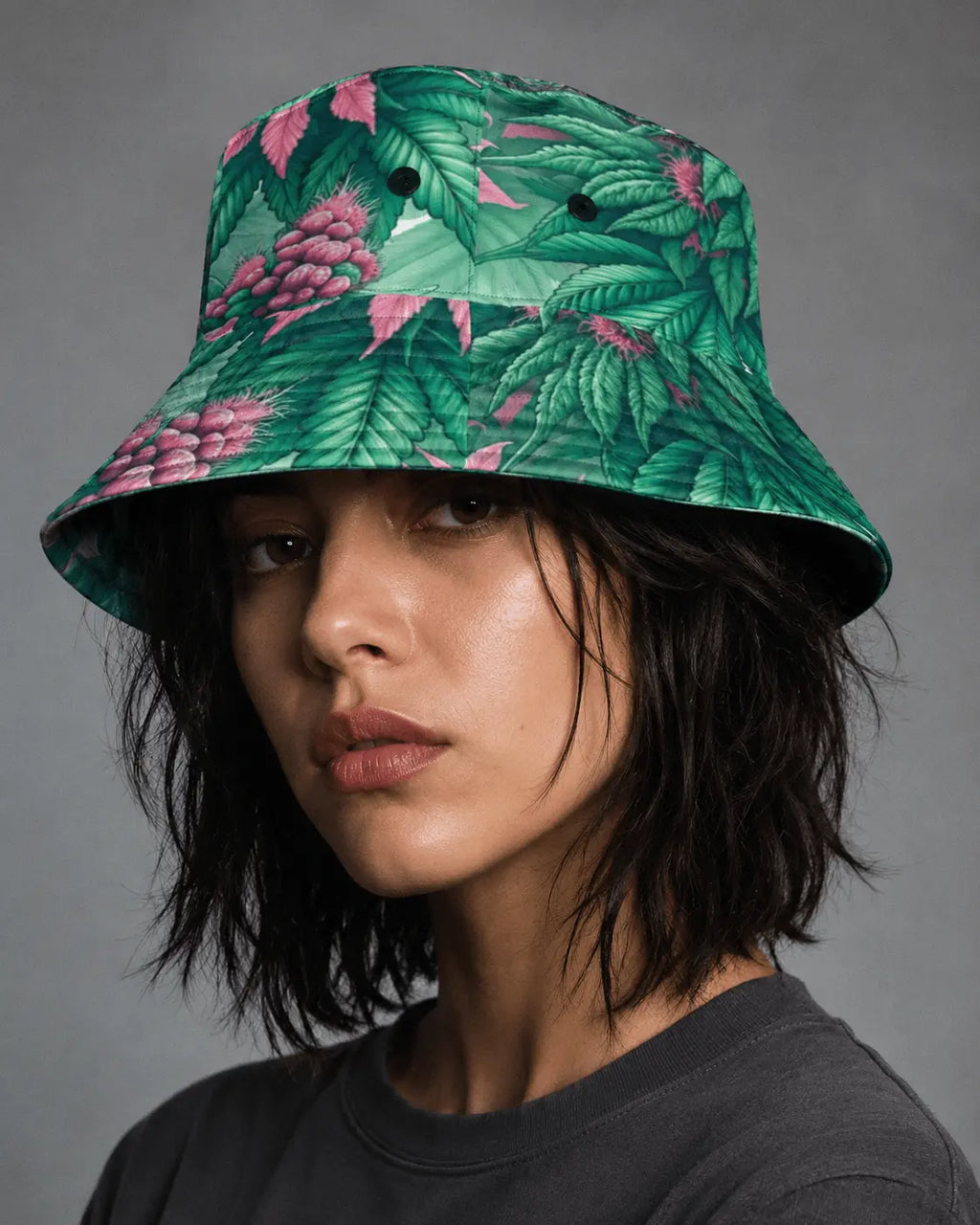 Jane Dope Pink Haze Bucket Hat, front portrait on a model showing green and pink print and black eyelets