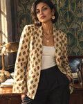 Polka Buds Blazer over an ivory tank and black trousers beside a sunlit vintage office desk.