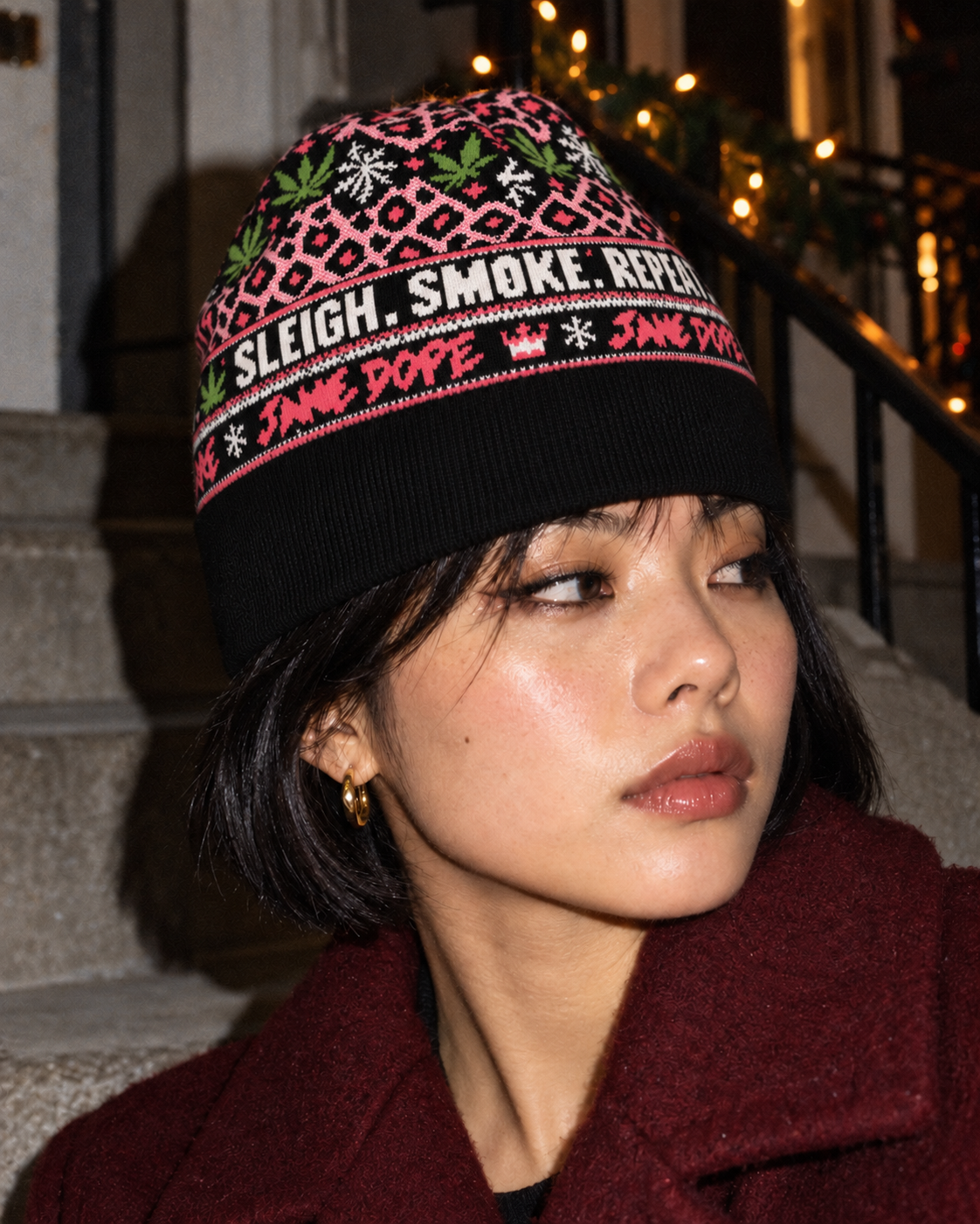 Three-quarter view of the Primo Holiday jacquard beanie styled with a burgundy coat.
