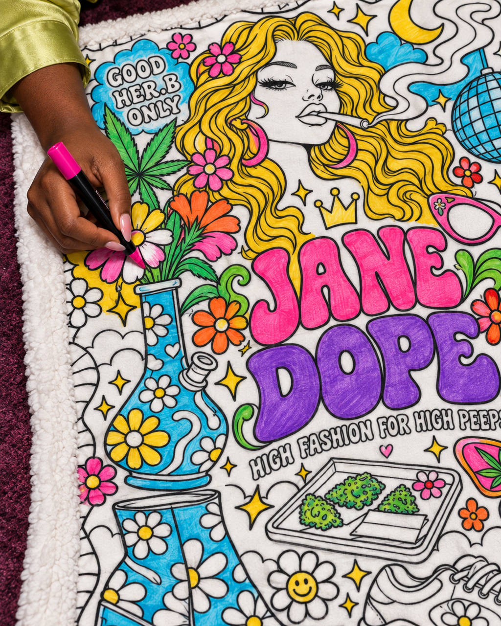 Retro Jane Dope blanket colouring inspiration: close-up of a hand adding pink marker colour inside a flower outline; product supplied uncoloured