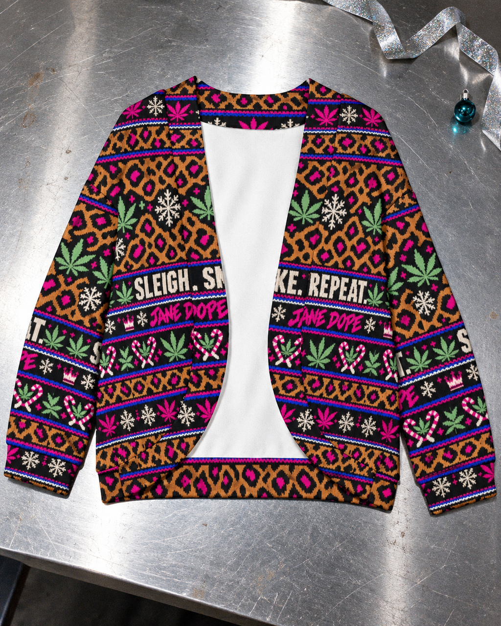 Sleigh. Smoke. Repeat open-front cardigan laid flat, showing leopard, Herb leaf and holiday print