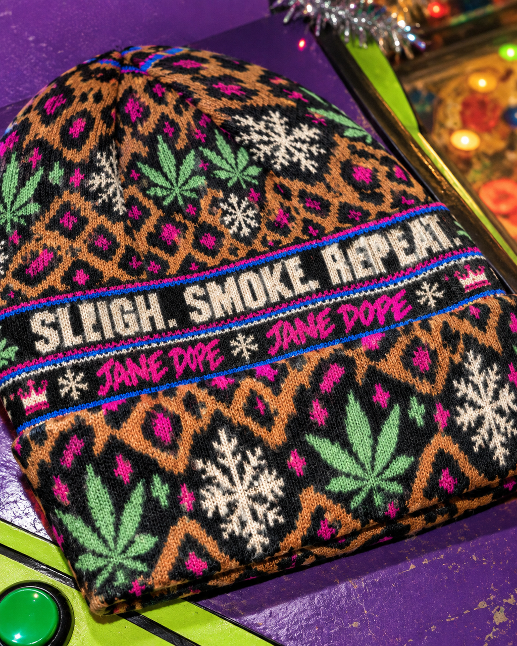 Close-up of All-Over Print Knitted Hat knit texture, patterned folded cuff and hot-pink Jane Dope lettering
