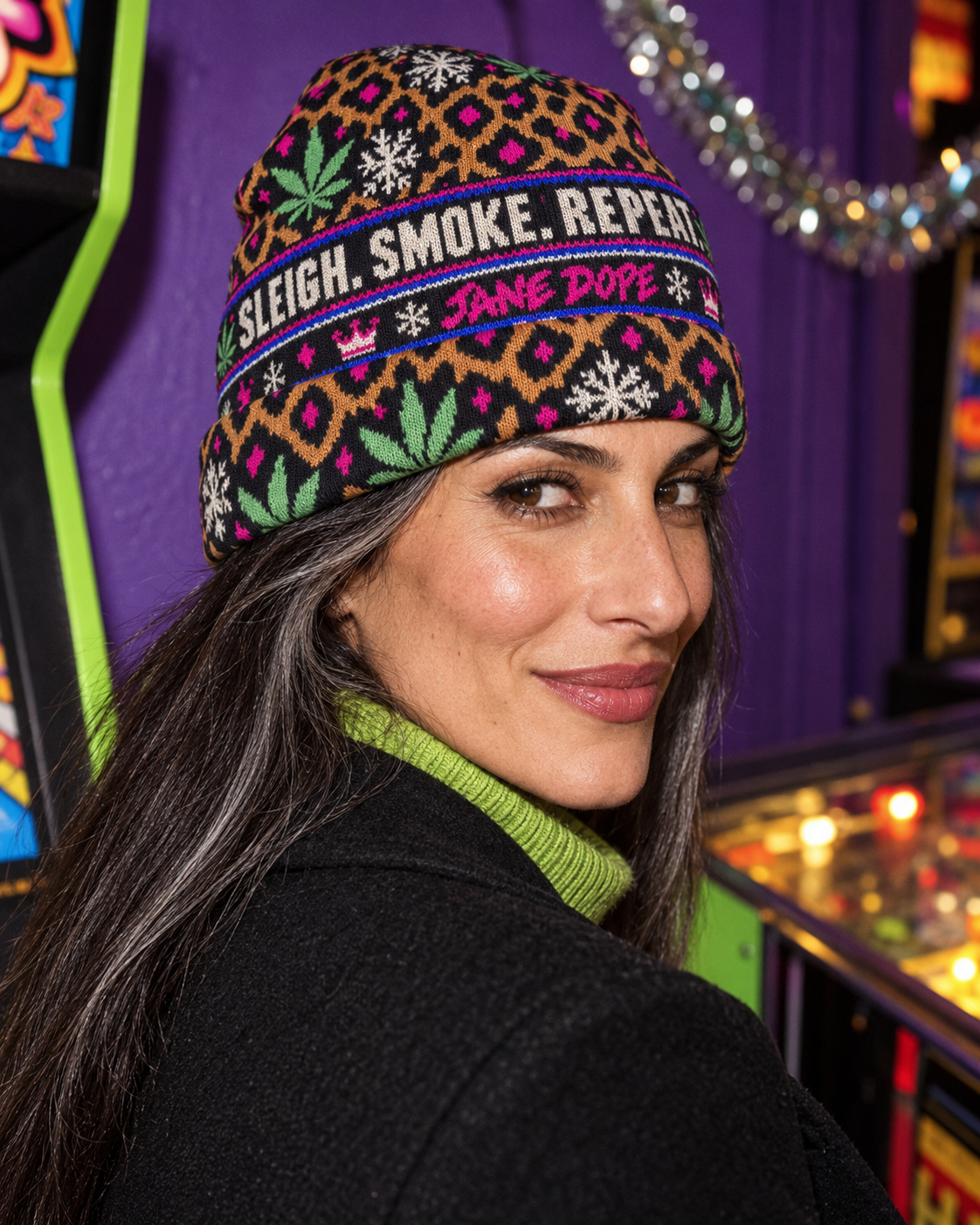 Close side view of All-Over Print Knitted Hat worn with a lime rollneck, showing the folded cuff and holiday print
