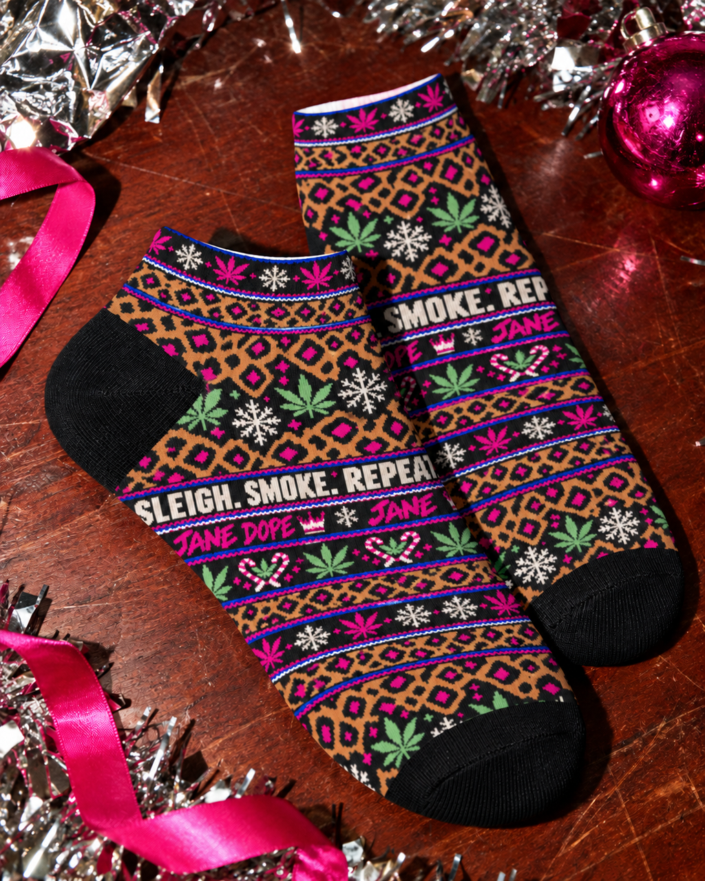 Smoke Sleigh Repeat ankle socks close-up showing black heel panels, short cuffs and festive leopard print.