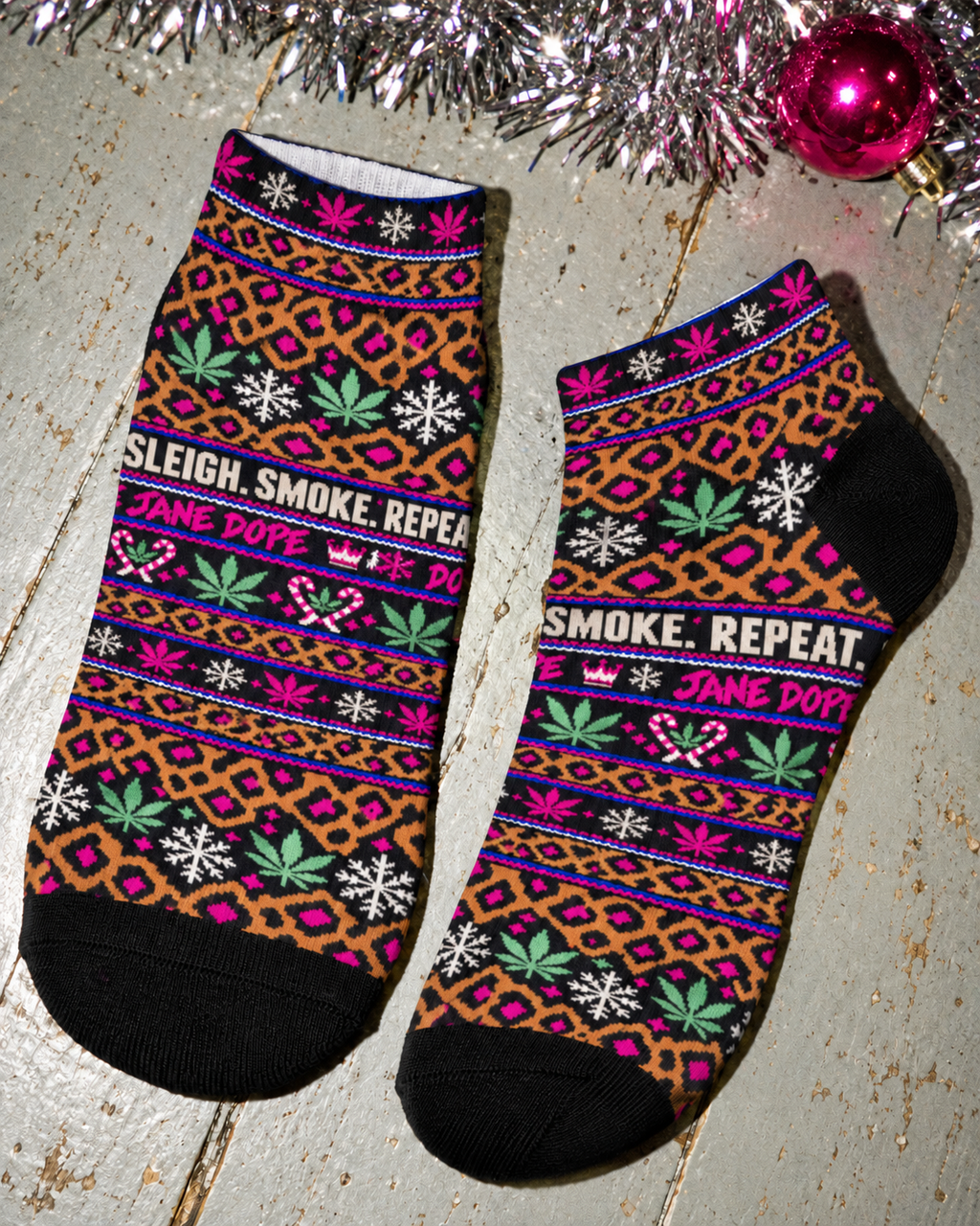 Jane Dope Smoke Sleigh Repeat Christmas ankle socks, leopard and pink pair with black toes and heels.
