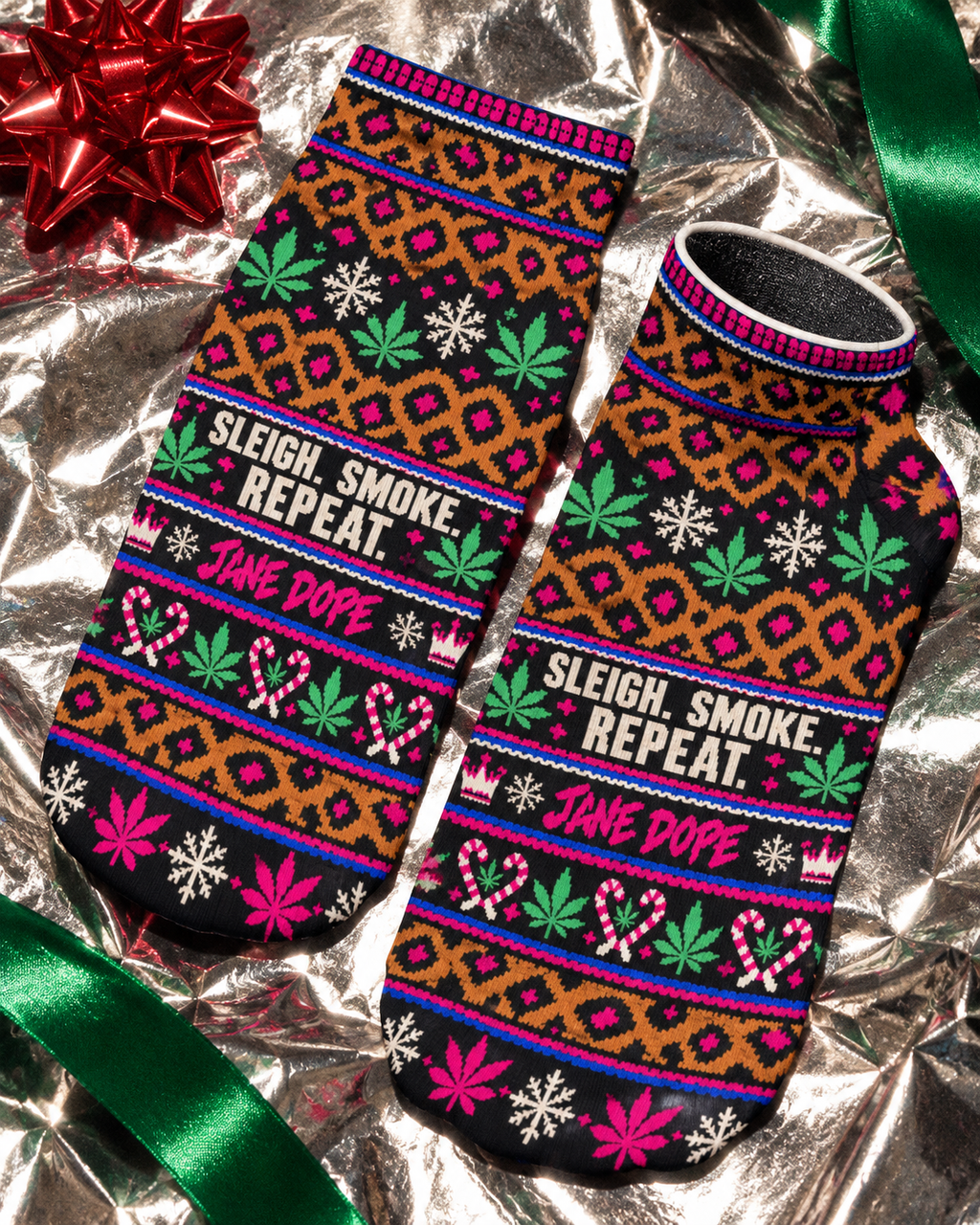 Close-up of Smoke Sleigh Repeat ankle socks showing pink Jane Dope lettering, candy cane hearts and leopard bands.