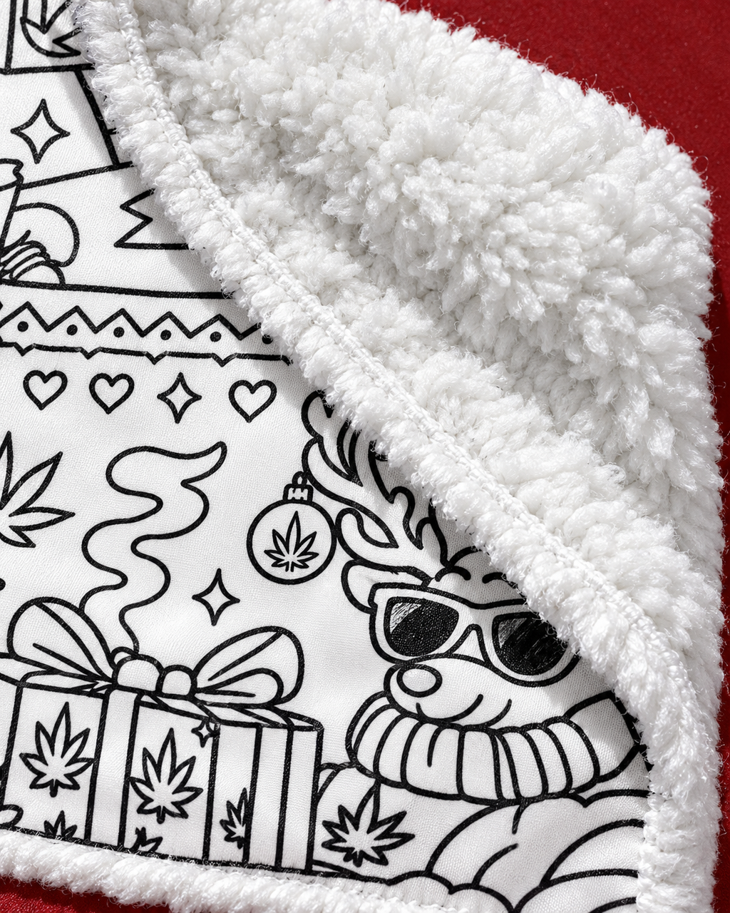 So Lit Xmas blanket detail showing reindeer line art, the stitched edge and plush white fleece reverse