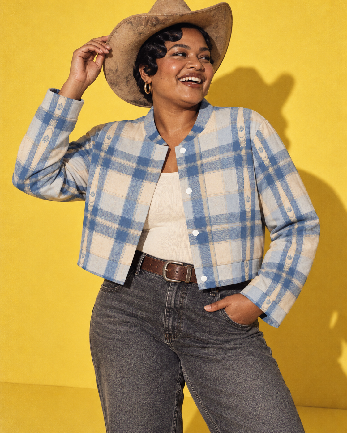 Sunday Sesh cropped jacket worn open with cream knit, charcoal denim and a tan Western hat in the yellow studio.