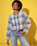 Sunday Sesh blue-and-cream plaid cropped jacket, closed front with four white snaps, denim and a Western belt on yellow.