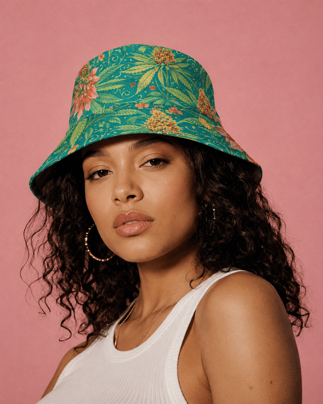 Woman wearing a colorful floral bucket hat against a pink background