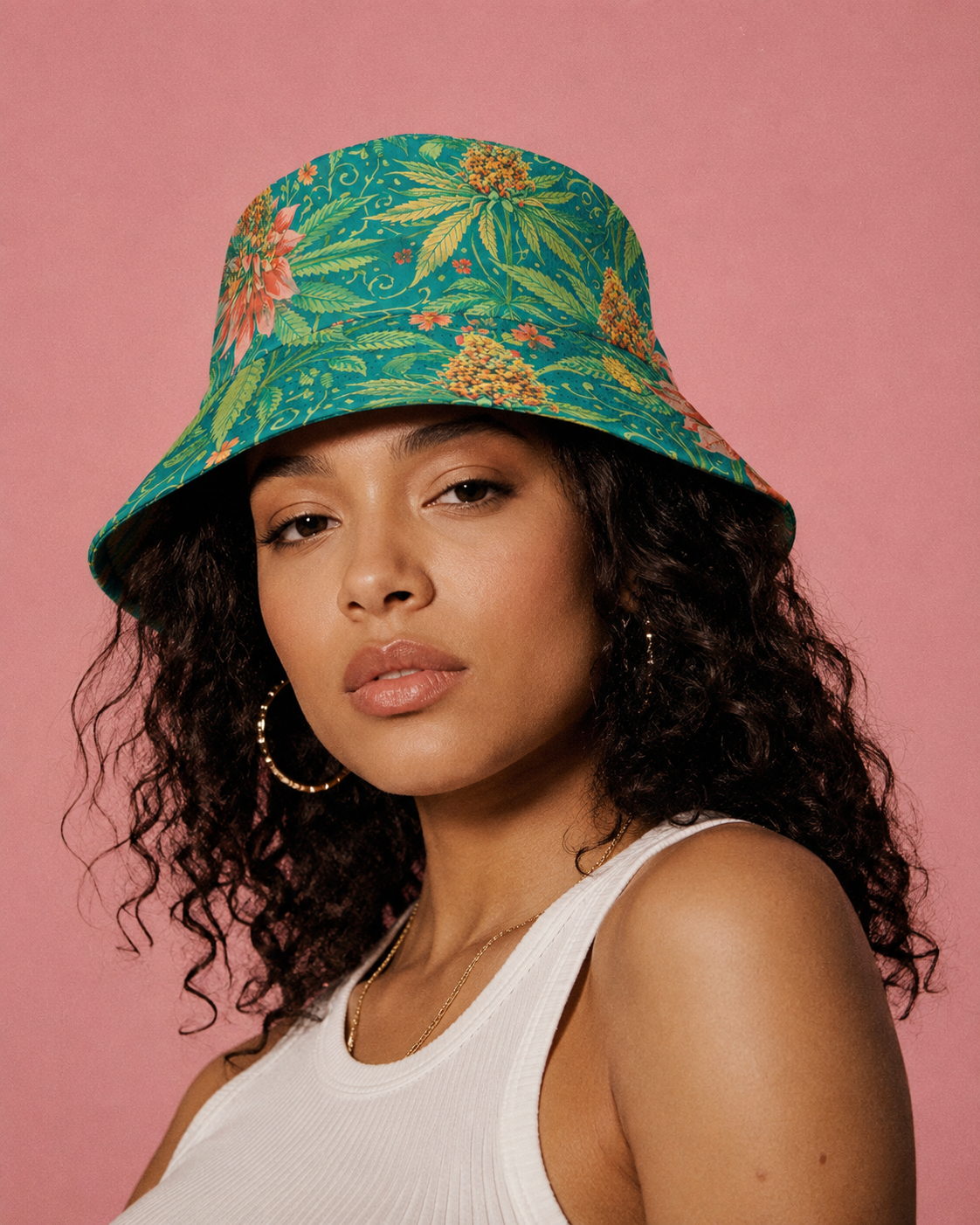 Woman wearing a colorful floral bucket hat against a pink background