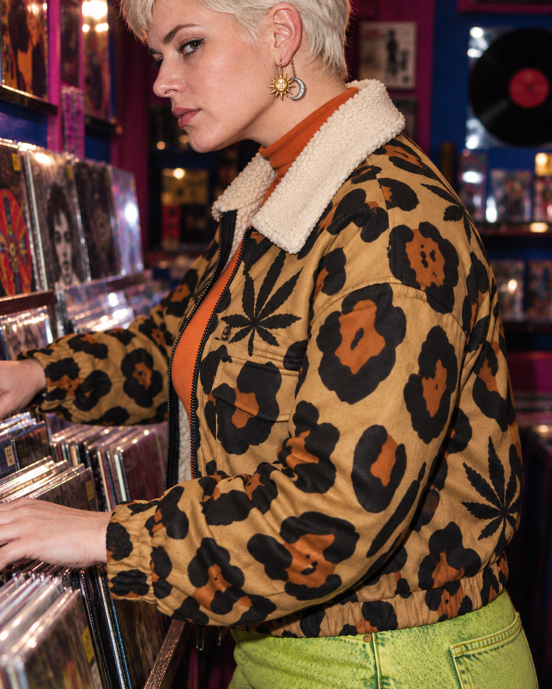 Close side view in a record shop showing the Leopard jacket collar, sleeve, cuff and cropped hem.