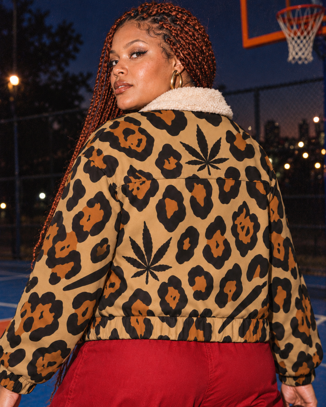 Back view of the Leopard jacket with Herb leaf above the yoke, against a blue basketball court.