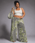 Leopard print wide leg pants, seated lifestyle shot on model