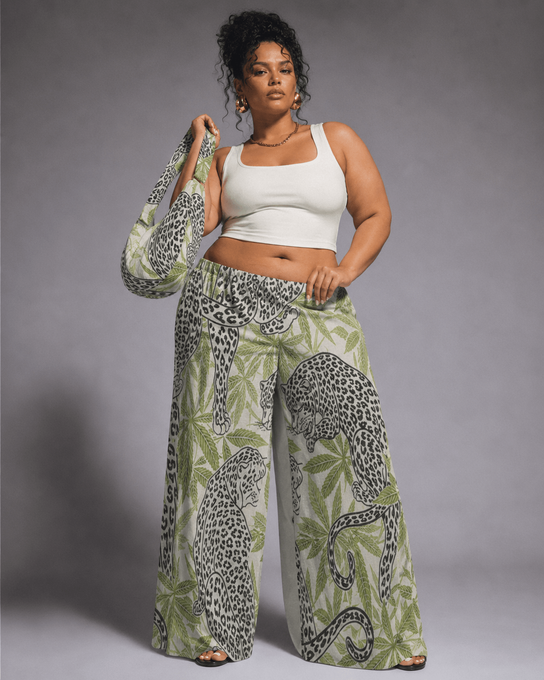 Leopard print wide leg pants, seated lifestyle shot on model