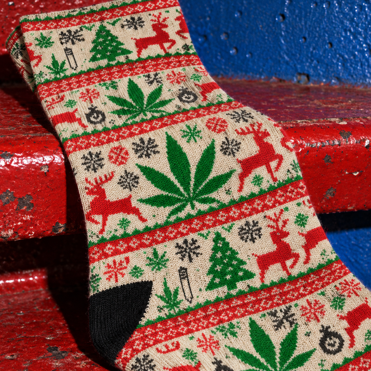 OG Xmas Socks close-up of green Herb leaves, red reindeer and smooth stretch fabric