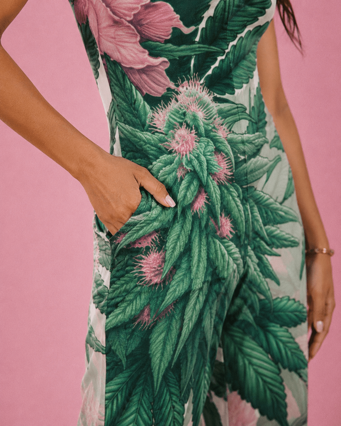 Pink haze floral print long jumpsuit, seated lifestyle shot on model