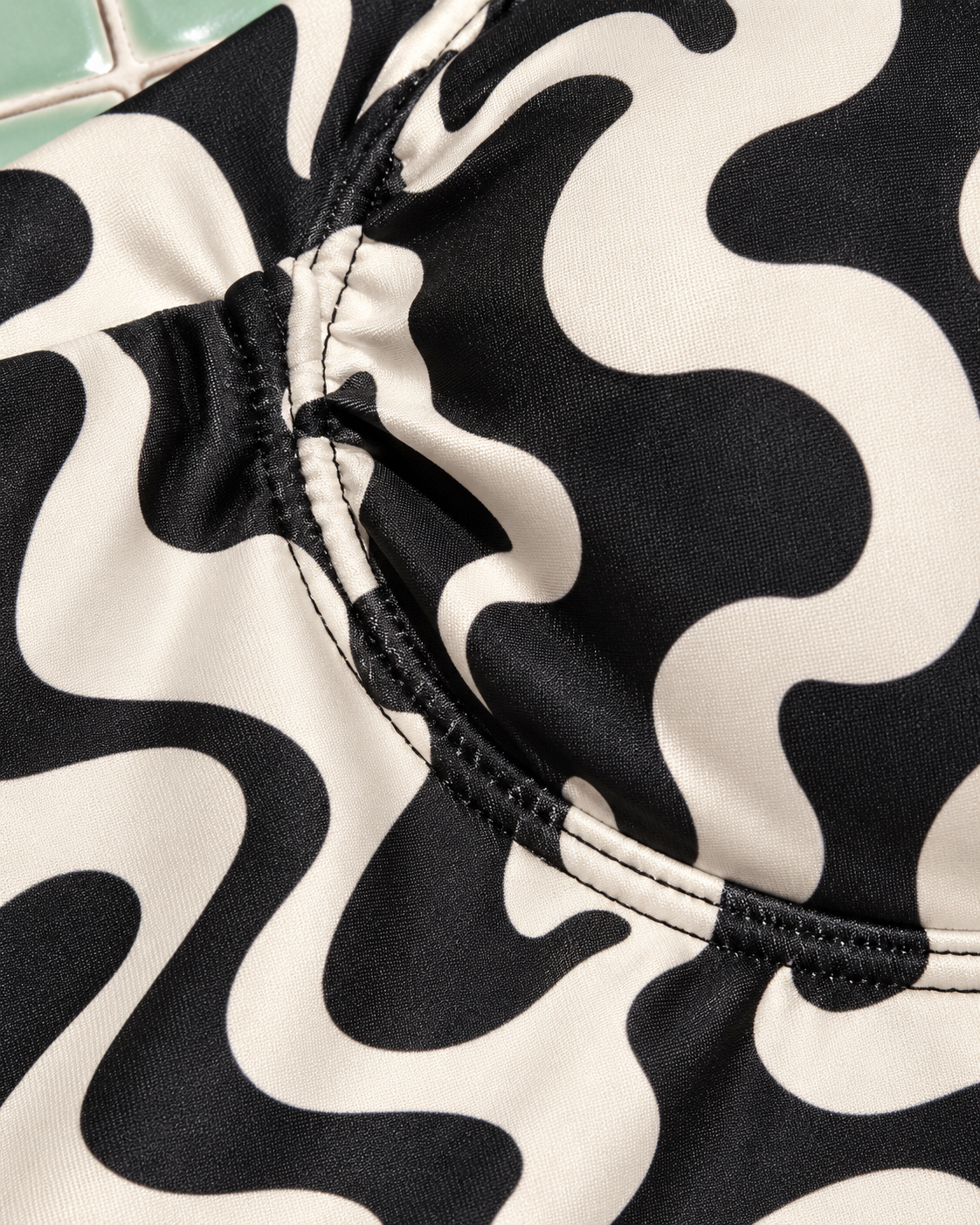 Puff Pin Up black-and-cream swimsuit fabric and curved seam close-up