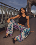 Graphic print wide leg flow pants, full length view on model outdoors