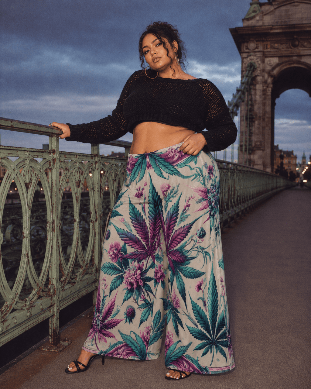 Graphic print wide leg flow pants, seated lifestyle shot on model
