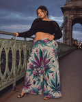 Graphic print wide leg flow pants, seated lifestyle shot on model