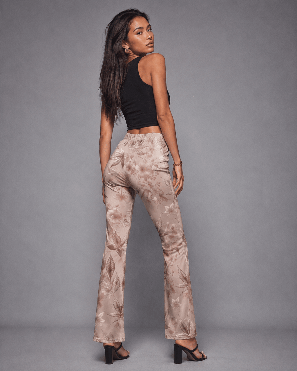 Rose graphic print flare pants, side view on model