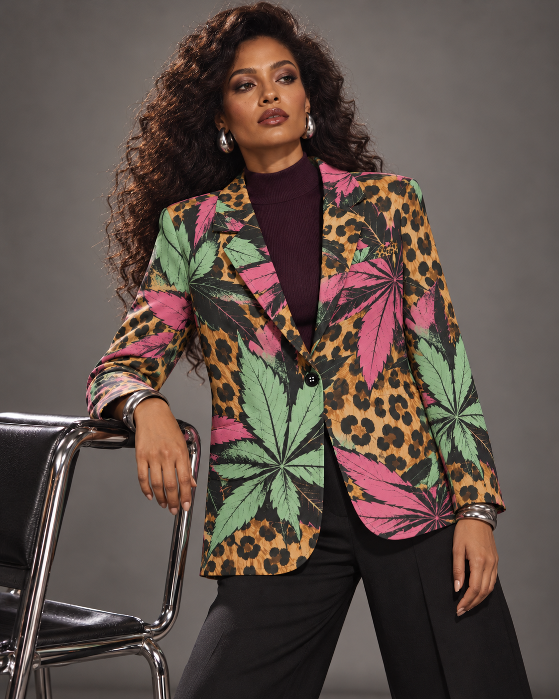 Runtz pink and mint botanical leopard-print blazer, leaning beside a chrome chair with a plum knit top. AI editorial illustration; styling accessories not included.