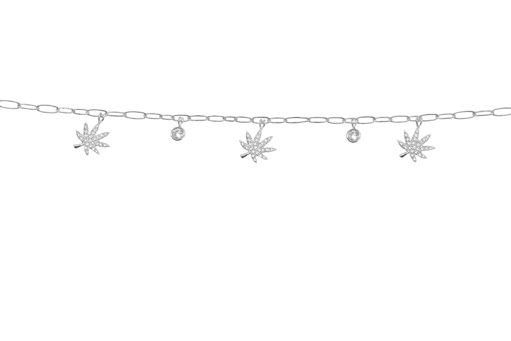 Silver charmed bracelet with botanical charms, product shot on white background