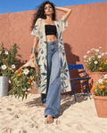 Soft Sativa long mesh cardigan by Jane Dope. Flower-market arrival: cream and navy botanical print styled in a sandy flower-market editorial.