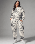 Green leaf print hoodie and sweatpants set, walking shot on model