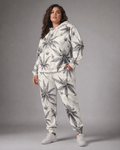 Green leaf print hoodie and sweatpants set, close-up showing fabric and print detail