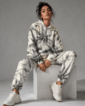 Green leaf print hoodie and sweatpants set, side view on model
