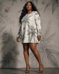 Leaf print long sleeve patchwork t-shirt dress, seated lifestyle shot on model
