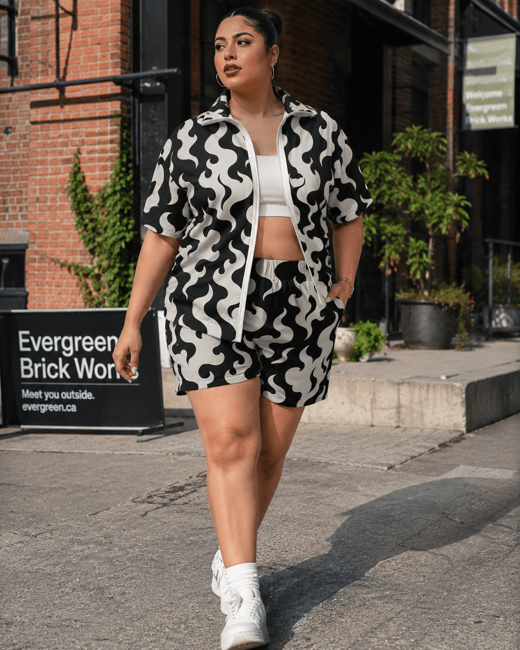 All-over print windbreaker and shorts set, seated lifestyle shot on model