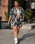 All-over print windbreaker and shorts set, seated lifestyle shot on model